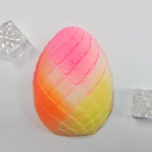 Mango bath bomb with a flashing disco cube